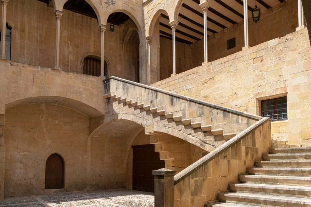 Elegant stone staircase in the Episcopal Palace courtyard, Tortosa, Spain.