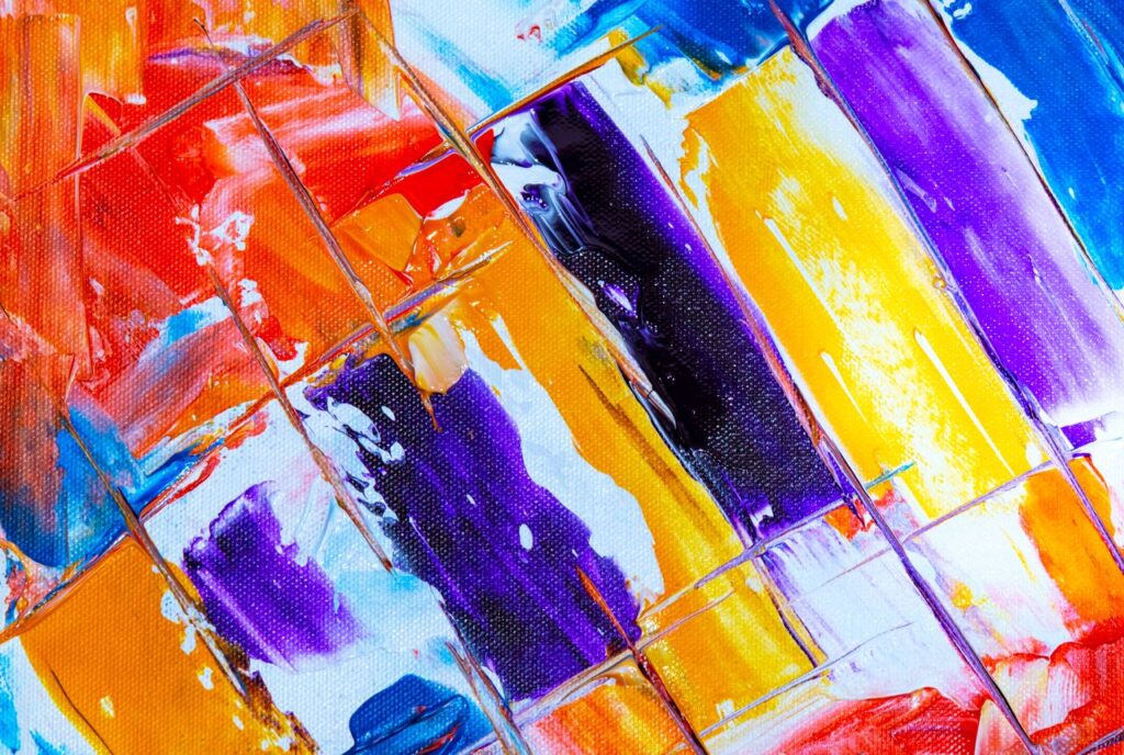Colorful abstract painting with bold brushstrokes and vibrant hues on canvas.