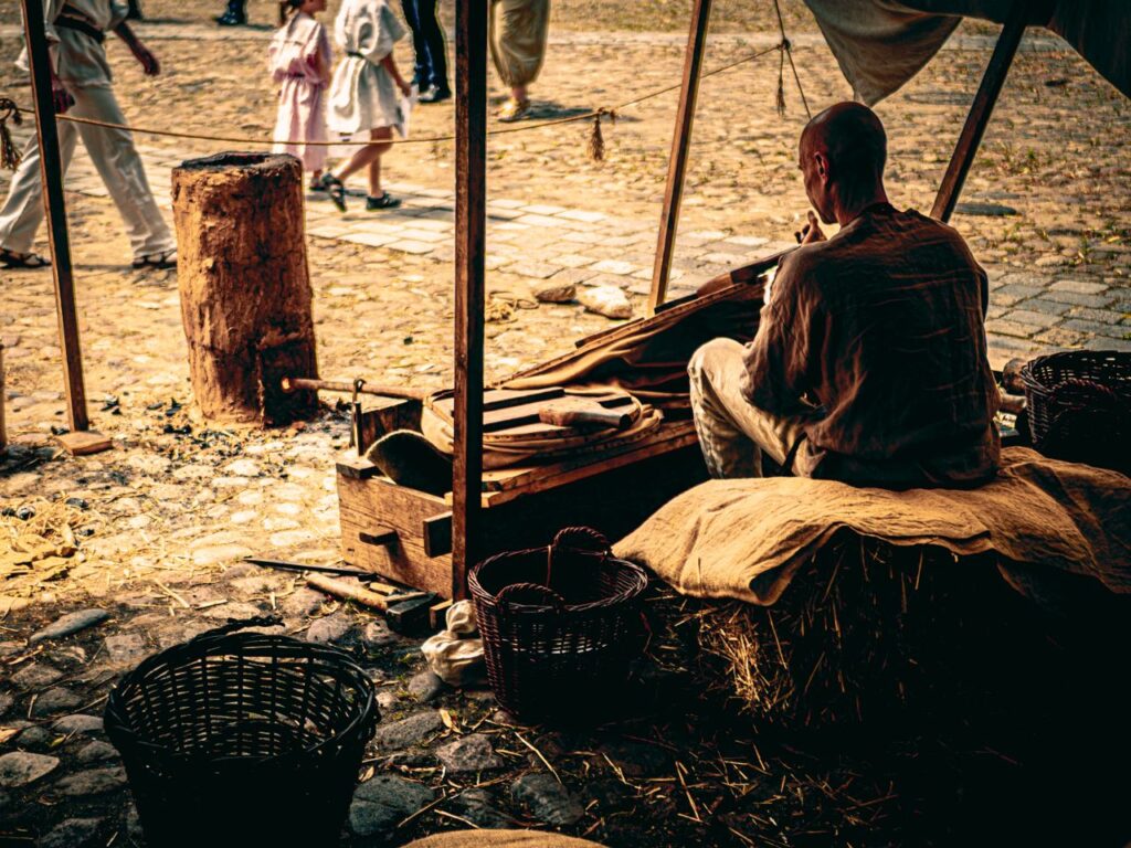 A craftsman at a historical festival in Wrocław, showcasing traditional craftsmanship techniques outdoors.